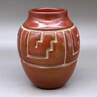 A red jar carved around the shoulder with a four panel kiva step and geometric design
 by Jennie Trammel of Santa Clara