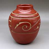 A short neck red water jar carved around the shoulder with a two panel stylized avanyu design
 by Jennie Trammel of Santa Clara