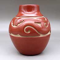 A red jar carved around the shoulder with an avanyu and geometric design, click or tap to see a larger version