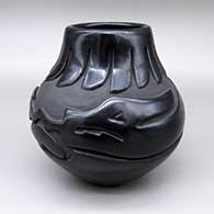 Black jar with a carved avanyu and feather ring geometric design
 by Sharon Naranjo Garcia of Santa Clara