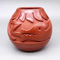 Red jar with a carved avanyu and feather ring geometric design
 by Mida Tafoya of Santa Clara