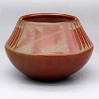 A buff-on-red jar decorated with a feather and geometric design above the shoulder
 by Maria Martinez of San Ildefonso