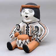 A sitting grandfather drummer storyteller figure with two children
 by Martha Arquero of Cochiti