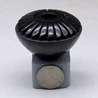 Click for a larger view A miniature black seed pot decorated with a carved ring of feathers above the shoulder
by Nancy Youngblood of Santa Clara