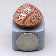 A miniature seed pot decorated with a sgraffito and painted butterfly, flower and geometric design
 by Rosemary Lonewolf of Santa Clara