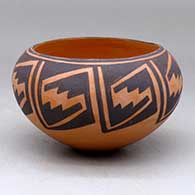 A black on red bowl decorated with a locks-and-keys geometric design
 by Carmel Lewis of Acoma