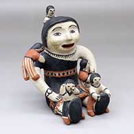 A sitting grandmother storyteller figure with five children
 by Seferina Ortiz of Cochiti