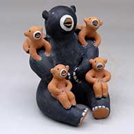 A sitting bear storyteller with four cubs
 by Louis Naranjo of Cochiti