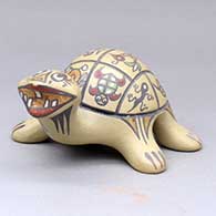 A polychrome turtle figure decorated with a lightly carved and painted insect, animal, fish and geometric design
 by Margaret and Luther Gutierrez of Santa Clara