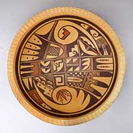 An open polychrome bowl with a corrugated rim and decorated on the inside with a bird hanging from sky band and geometric design
 by Dee Setalla of Hopi