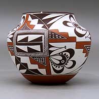 A polychrome jar decorated with a three-panel geometric design, click or tap to see a larger version