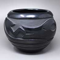 A black jar carved with an avanyu design around the body
 by Pablita Chavarria of Santa Clara