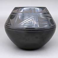 A black on black jar with a geometric design, click or tap to see a larger version