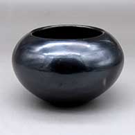 A plain, polished black bowl with fire clouds
 by Maria Martinez of San Ildefonso