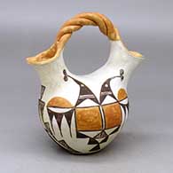 A small polychrome wedding vase with a twisted bridge and decorated with a bird element and geometric design
 by Edna Chino of Acoma