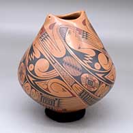 A polychrome jar with an organic opening and decorated with a four-panel Paquime-style geometric design
 by Cesar Dominguez of Mata Ortiz and Casas Grandes