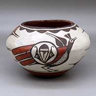 A polychrome jar decorated around the body with a two panel roadrunner and geometric design
 by Seferina Bell of Zia