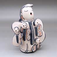 A standing butterfly storyteller figure with six babies
 by Snowflake Flower of Cochiti