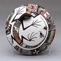 A polychrome seed pot decorated with appliques and a lizard, lady bug and geometric design
 by Carolyn Concho of Acoma