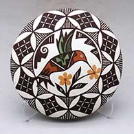 A polychrome seed pot decorated with a hummingbird, flower, fine line and geometric design
 by Marilyn Ray of Acoma