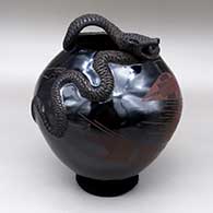Red on black jar with an applique rattlesnake and a painted geometric design
 by Rito Talavera of Mata Ortiz and Casas Grandes