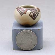 A miniature polychrome bowl decorated with a two panel bird element and geometric design
 by Nathan Begaye of Hopi