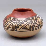 A small polychrome jar decorated around the body with a geometric design
 by Nathan Begaye of Hopi