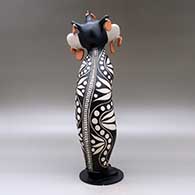 Old man caterpillar with seven earrings and decorated with a geometric design and a custom stand, click or tap to see a larger version