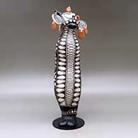 Old man caterpillar with seven earrings and decorated with a geometric design and a custom stand, click or tap to see a larger version