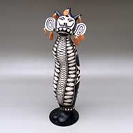 Old man caterpillar with seven earrings and decorated with a geometric design and a custom stand
 by Virgil Ortiz of Cochiti