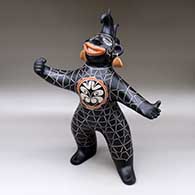 A standing polychrome opera singer figure in costume with earrings
 by Lisa Holt of Cochiti