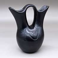 A black wedding vase decorated on two sides with a bear paw imprint
 by Richard Ebelacker of Santa Clara