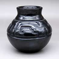 A black jar with a recurved neck and carved with a two-panel stylized avanyu geometric design
 by Richard Ebelacker of Santa Clara