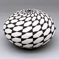 A black-on-white seed pot decorated with a spiraling geometric design
 by Rose Chino Garcia of Acoma