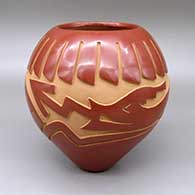 Red jar with a carved avanyu and feather ring geometric design
 by Ethel Vigil of Santa Clara