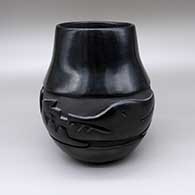 Black jar with a carved avanyu design
 by Mida Tafoya of Santa Clara