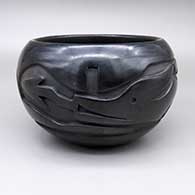 Black bowl with a carved avanyu design
 by Christina Naranjo of Santa Clara