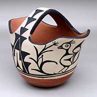 A polychrome pitcher with two spouts and decorated with a four-panel bird and geometric design
 by Vidal Aguilar of Santo Domingo