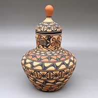 Polychrome lidded jar with a roadrunner, flower, butterfly, and geometric design
 by Thomas Tenorio of Santo Domingo