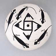 A black-on-white seed pot decorated with a whirling log, lizard and geometric design
 by Donna Chino of Acoma