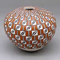 A polychrome seed pot decorated with a stylized checkerboard and geometric design
 by Grace Chino of Acoma