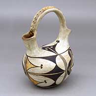 A polychrome wedding vase with a corrugated handle and decorated around the body with a four-panel cloud element and geometric design
 by Unknown of Acoma