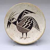 A black-on-white plate decorated with a Mimbres bird and geometric design
 by Anita Lowden of Acoma