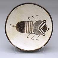 A black-on-white plate decorated with  Mimbres insect and geometric design
 by Anita Lowden of Acoma