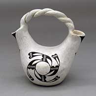 A black-on-white wedding vase with a twisted handle and decorated with a whirling cloud formation and geometric design
 by Rebecca Lucario of Acoma