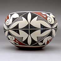 A polychrome jar decorated with a four-panel geometric design, click or tap to see a larger version