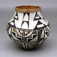 A polychrome jar with a band of corrugation around the rim and decorated with a four-panel black-on-white geometric design
 by Unknown of Acoma