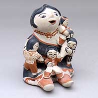 A sitting grandmother storyteller figure with four children
 by Felicita Eustace of Cochiti