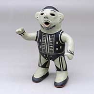 A standing, black-on-white bearded opera singer figure decorated with a geometric design
 by Martha Arquero of Cochiti