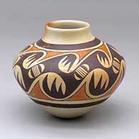 A polychrome jar with a raised rim and decorated with a bat-wing migration pattern design
 by Unknown of Hopi